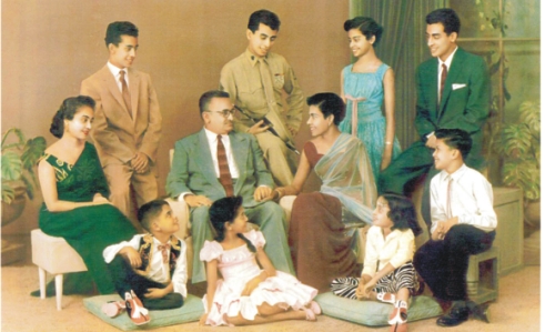 From back row: Jayam, Rajah, Iswari, Chandran. Seated: Indrani, James T. Rutnam (Father), Evelyn (Mother,) Dennis. Bottom row: George, Padmini and Niece Kshirabdhi. Picture taken in 1960 at Donalds Studio, Sri Lanka.