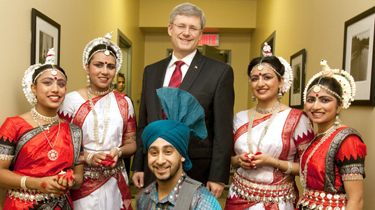 Canadian Prime Minister Stephen Harper poses for a picture with dancers during Diwali celebrations in Ottawa.