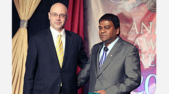 Christopher Dhanaraj won the Gold Award for Overall Top Producers of 2011. He also won the also won another award for individual company Top Producers, he is seen here during the presentation of the Industrial Alliance Award by Rob Harkness.