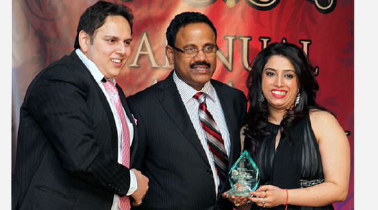 Raj Nadarajah CEO of Mega Financial Group presents Poonam Batth the UL- Mutual Individual Company Top Producer Award.