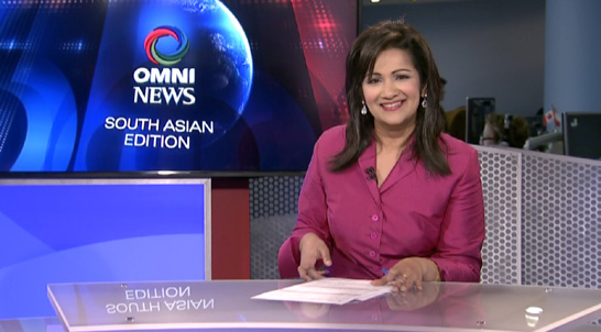 Sudha Krishnan delivering news in the new set for Omni.