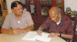 Lester  James Peiris  autographs one  of his books at his Dickmens Road residence,  Bambalapitiya, to remember 50 years of association with Sivanandan.