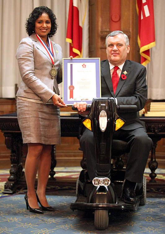 Meleni David receives the NEPMCC award for Community Service from Ontario Lt. Governor David Onley.