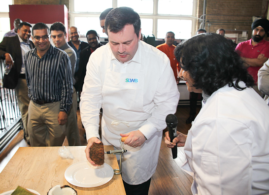 Canadian Minister Jason Kenney scrapes a coconut while learning how to prepare a sambol. (Pictures by Mahesh Abeyewardene)