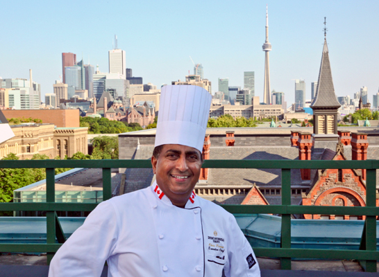 Christopher Perera, Executive Chef InterContinental Toronto Yorkville on the hotel rooftop overlooking the city skyline. 