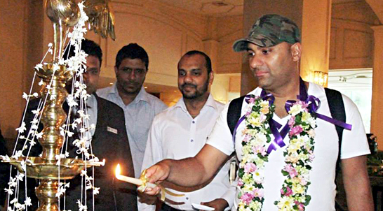 Russel Peters lights the traditional oil lamp in Colombo Hilton upon arrival. (Colombo show via Facebook)