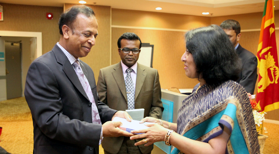 Professor Chelva presents an anthology on poetry to Sri Lankan High Commissioner to Canada Chitranganee Wagiswara and Sri Lanka Consul General to Toronto Karunaratne Paranawitana in June 2013.
