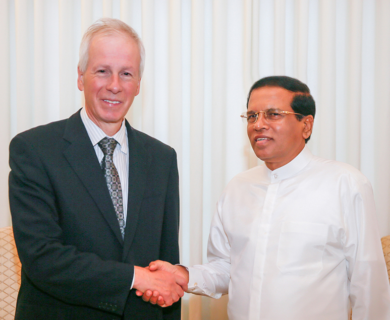 Dion shakes hands with President Sirisena.