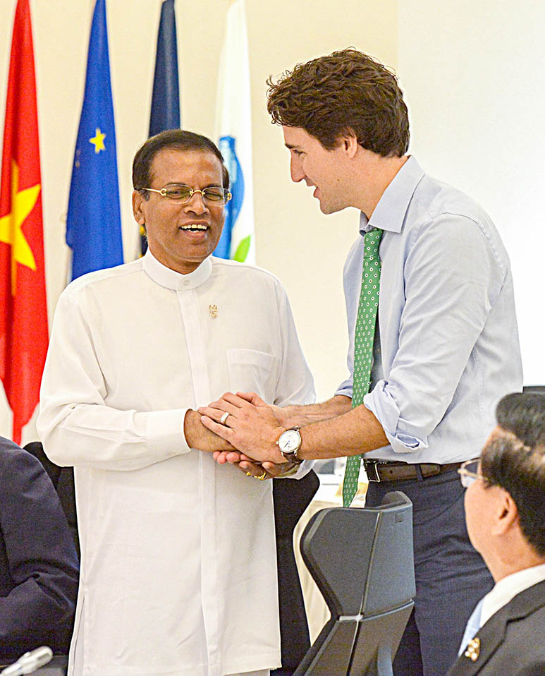 Prime Minister Trudeau and President Sirisena speak during the G7 Summit in Japan recently.