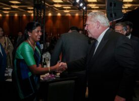 Premier Ford shakes hands with a woman at CTCC gala.