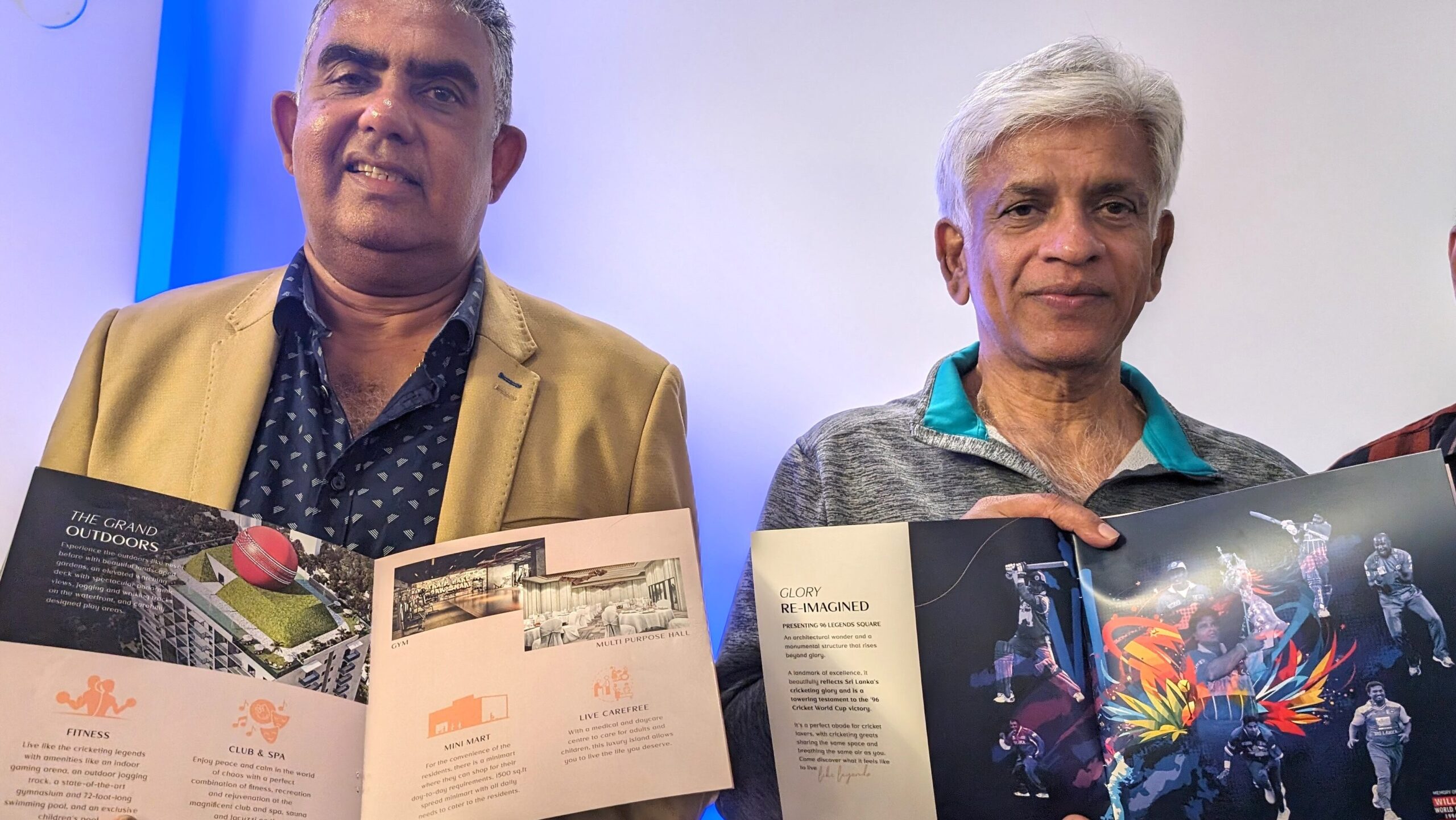 Arjuna Ranatunga and Asanka Gurusinghe display brochures.