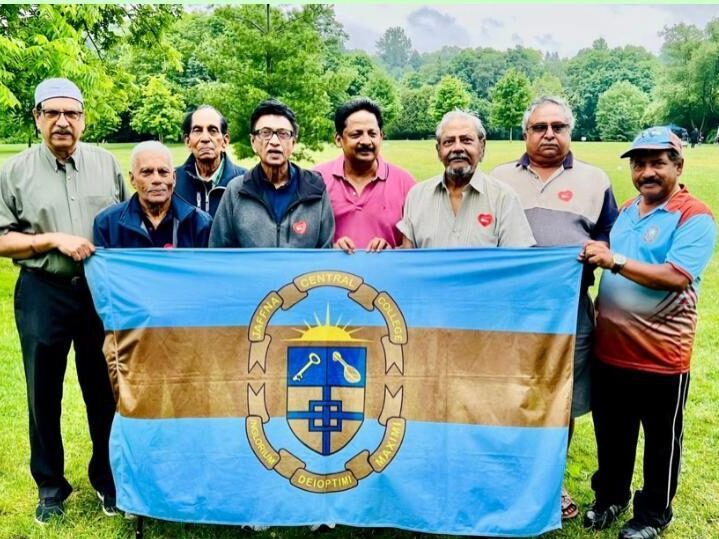 People hold the flag of Jaffna Central College.